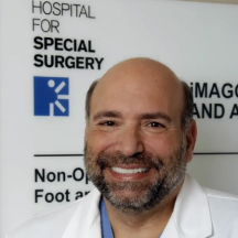 Rock G. Positano smiling with Hospital for Special Surgery logo in background