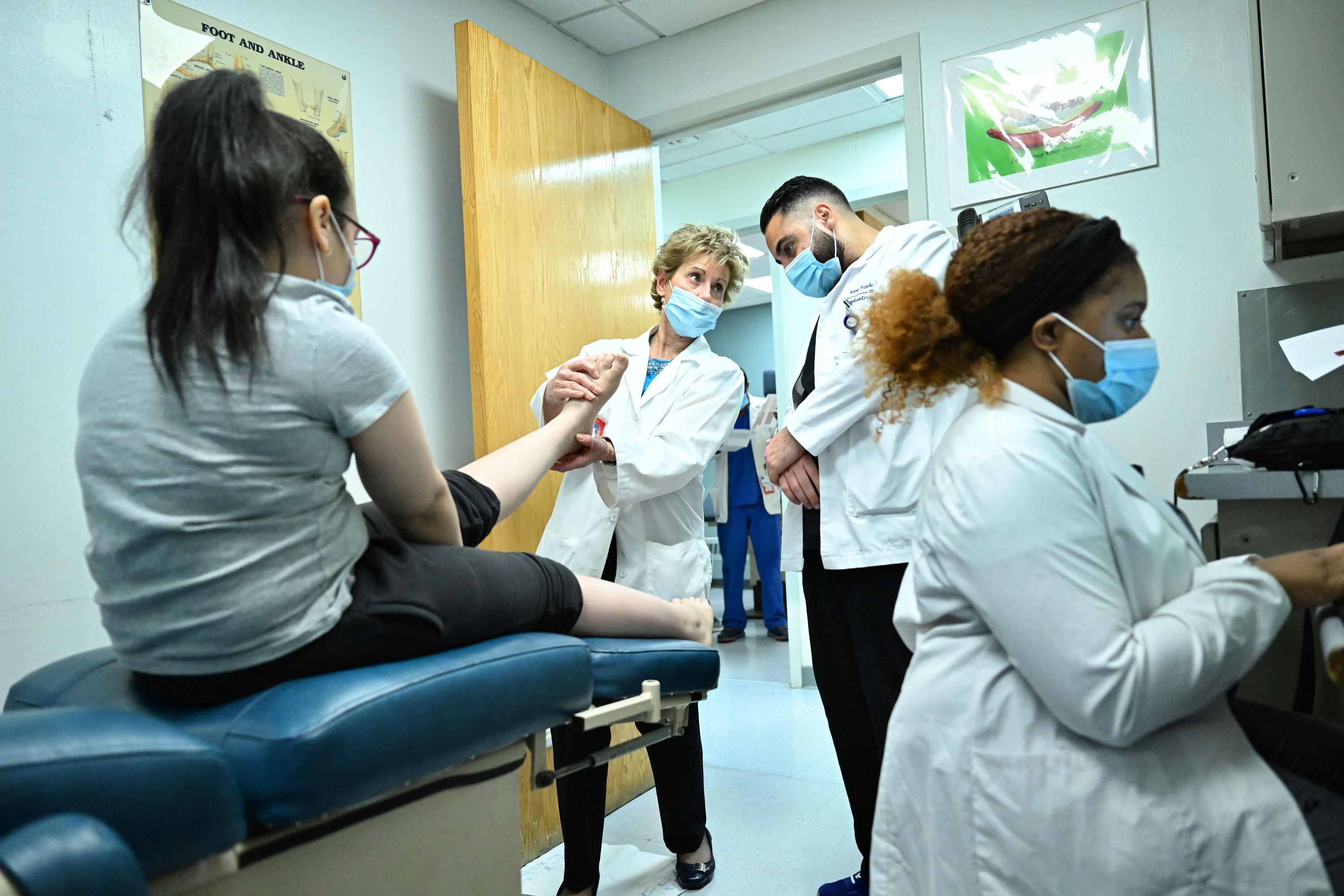 Students and faculty member working with patient at the Foot Center of NY.