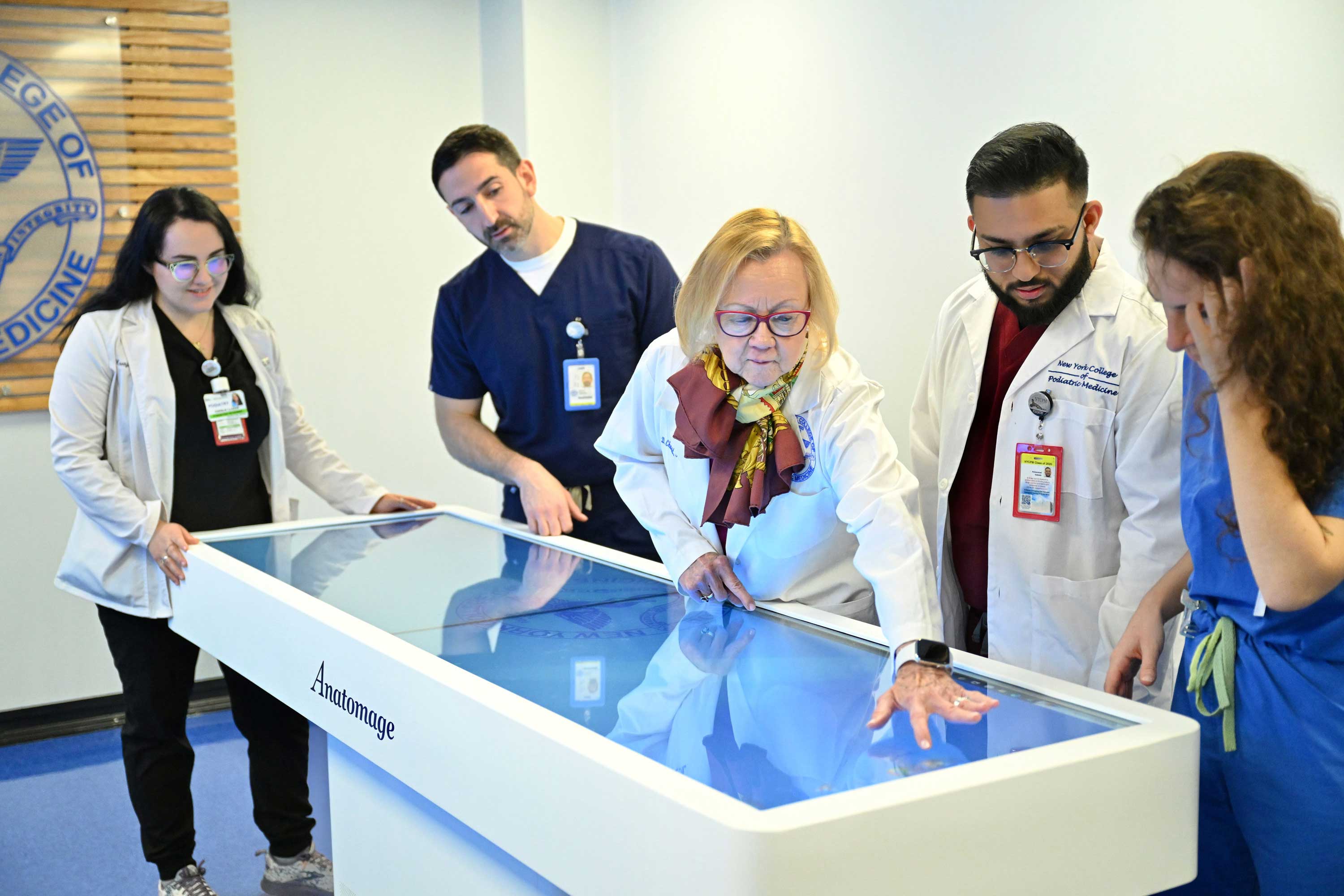 NYCPM faculty member working with students using Anatomage Table