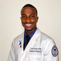 William Stalings smiling with white coat on